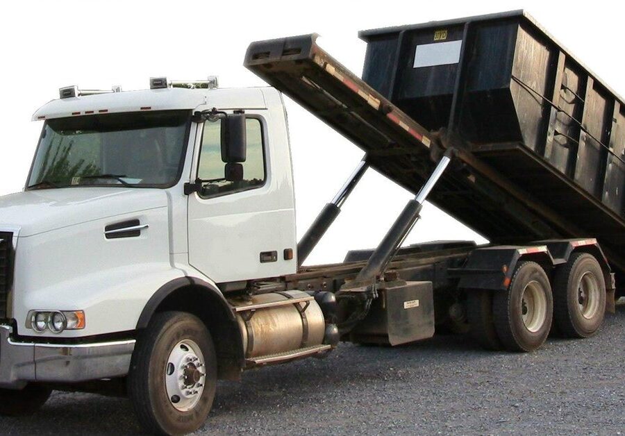 Roll-off truck carrying an empty disposal bin